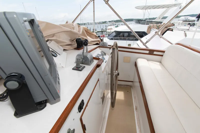 Slide: The Image of 1974 Grand Banks 42 Classic yacht helm with steering wheel and navigation equipment. - 11