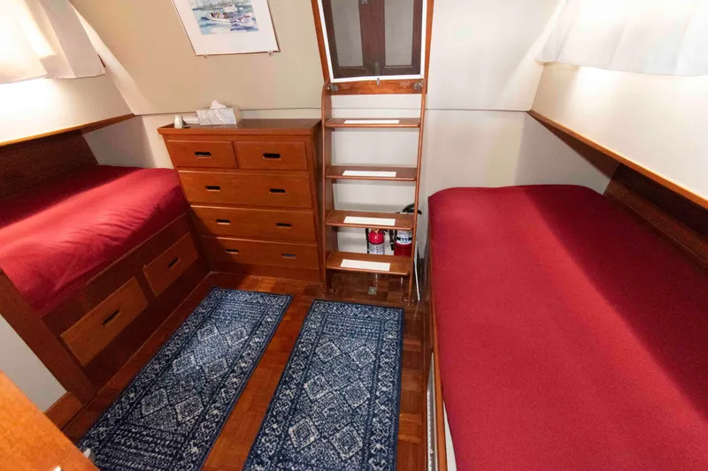 Slide: The Image of Cabin interior of 1974 Grand Banks 42 Classic with twin beds and wooden furniture. - 23