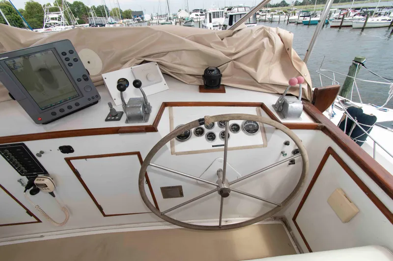 Slide: The Image of Helm of 1974 Grand Banks 42 Classic yacht with navigation equipment and controls. - 12
