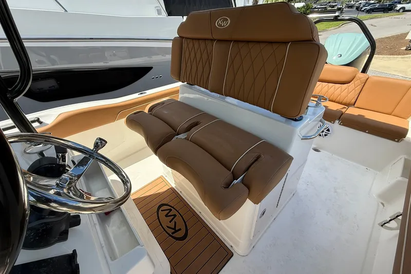 Slide: The Image of 2027 Key West 239 FS boat interior with tan leather seating and steering wheel. - 5