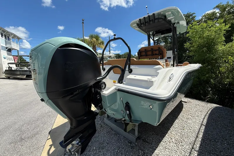 Slide: The Image of 2027 Key West 239 FS boat with powerful outboard motor, parked outdoors. - 1