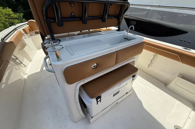 Slide: The Image of 2027 Key West 239 FS boat interior with seating, storage, and sink. - 8
