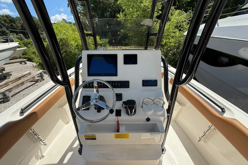 Slide: The Image of 2027 Key West 239 FS boat console with steering wheel and navigation controls. - 6