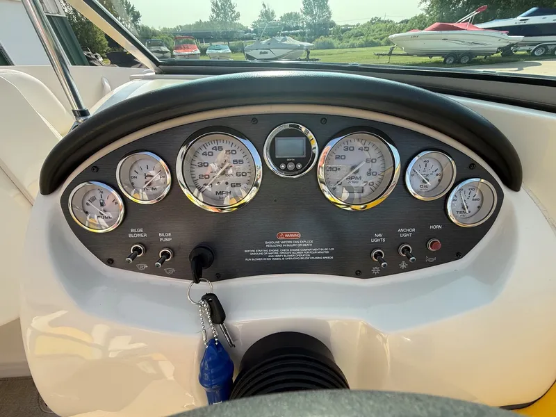Slide: The Image of Dashboard of a 2006 Sea Ray 185 Sport with multiple gauges and an ignition key. - 16