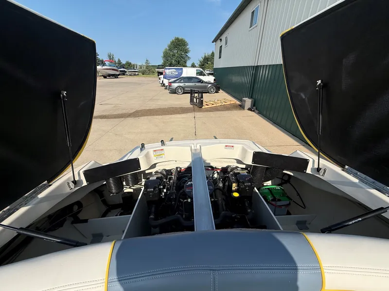 Slide: The Image of The engine compartment of a 2006 Sea Ray 185 Sport is open, revealing the engine and battery. - 23