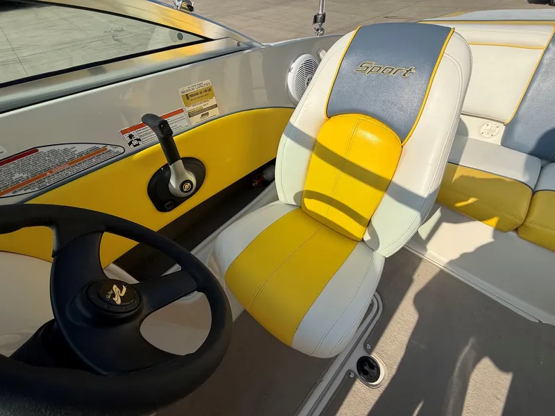 Slide: The Image of The interior of a 2006 Sea Ray 185 Sport with yellow and white seating. - 14