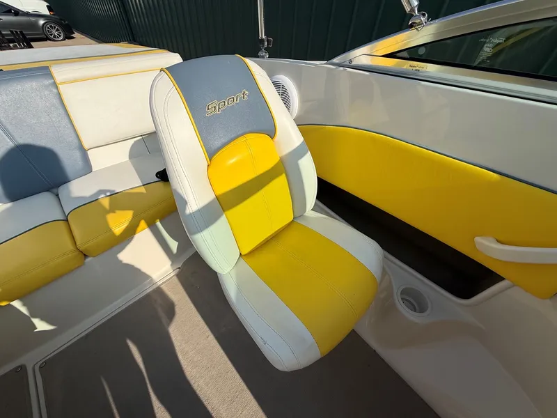 Slide: The Image of The interior of a 2006 Sea Ray 185 Sport with yellow and white seating. - 15
