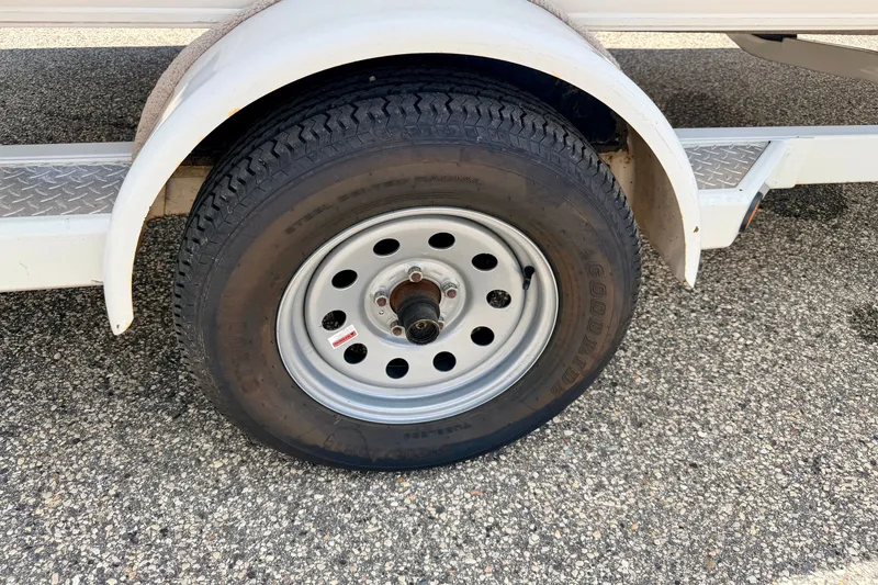 Slide: The Image of Trailer wheel of a 2005 Princecraft Vacanza 210V O/B on asphalt. - 74