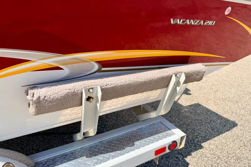 Slide: The Image of 2005 Princecraft Vacanza 210V O/B boat with red and yellow detailing on trailer. - 70