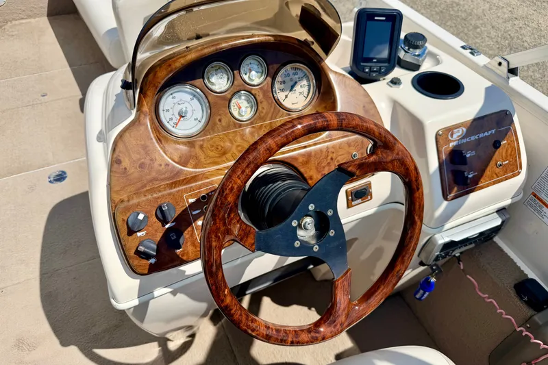 Slide: The Image of 2005 Princecraft Vacanza 210V O/B boat dashboard with wood accents and gauges. - 33