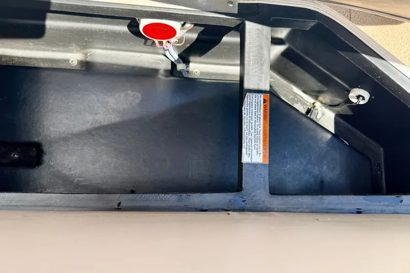 Slide: The Image of Storage compartment of a 2005 Princecraft Vacanza 210V O/B boat with warning label. - 27