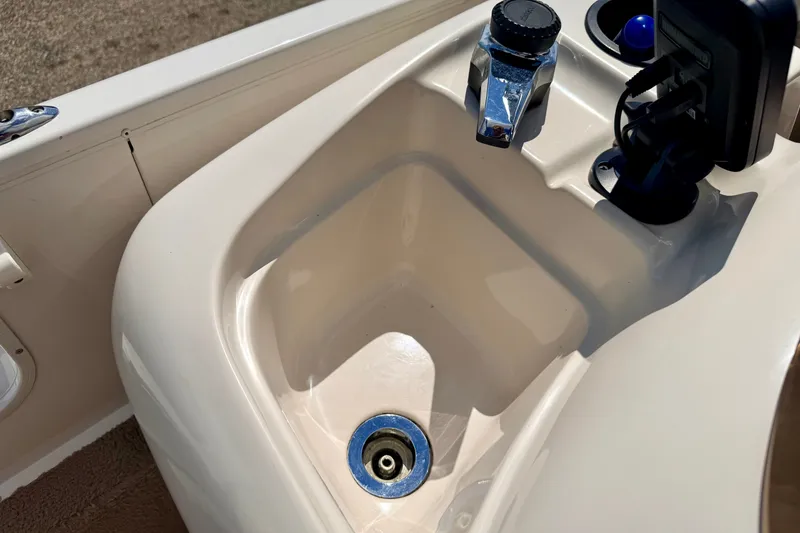Slide: The Image of 2005 Princecraft Vacanza 210V O/B boat sink with faucet and accessory holder. - 62