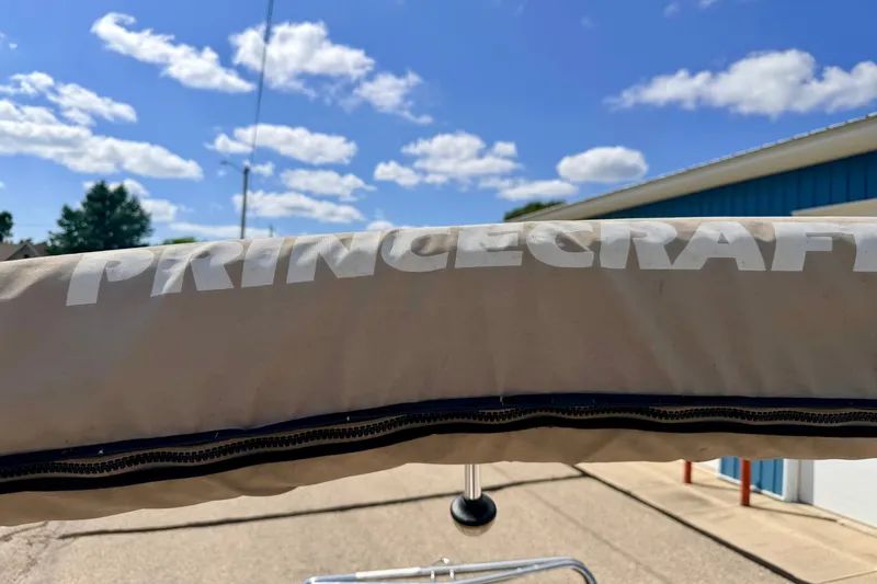Slide: The Image of 2005 Princecraft Vacanza 210V O/B boat cover under a clear blue sky. - 63