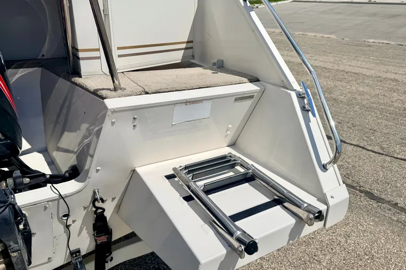 Slide: The Image of 2005 Princecraft Vacanza 210V O/B boat with foldable swim ladder and carpeted deck. - 22