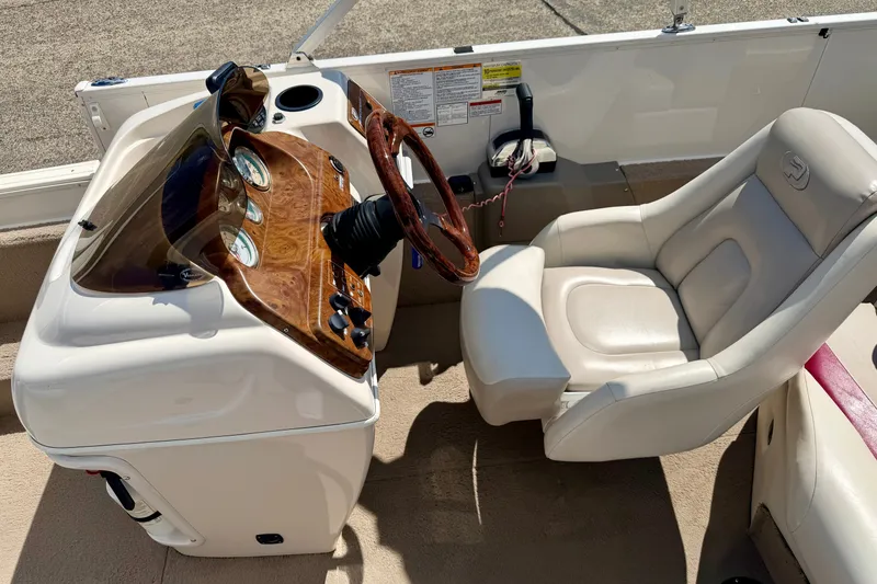 Slide: The Image of 2005 Princecraft Vacanza 210V O/B boat cockpit with steering wheel and captain's chair. - 32