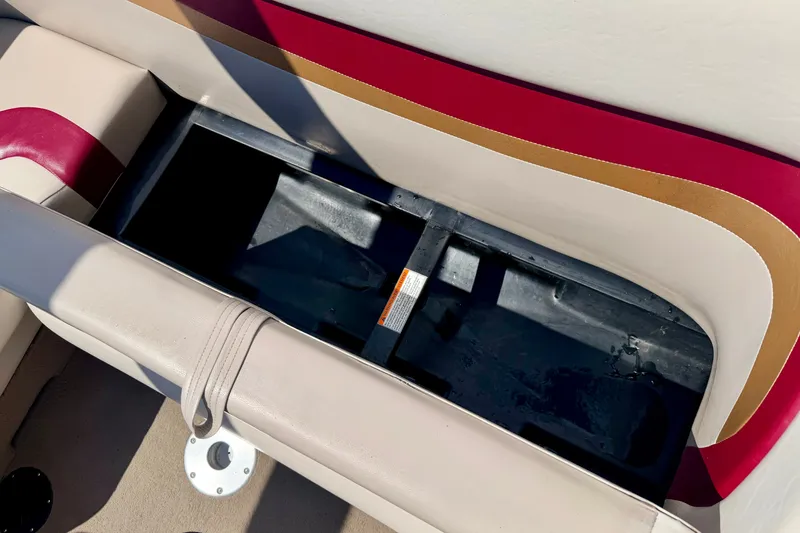 Slide: The Image of Storage compartment in a 2005 Princecraft Vacanza 210V O/B boat with beige and red upholstery. - 31