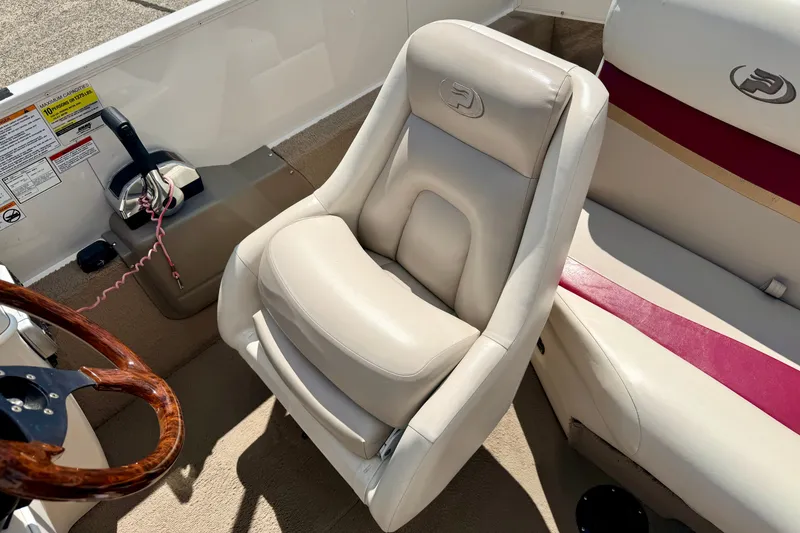 Slide: The Image of 2005 Princecraft Vacanza 210V O/B boat interior with plush seating and steering wheel. - 44