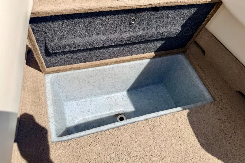 Slide: The Image of Storage compartment in 2005 Princecraft Vacanza 210V O/B boat, featuring carpeted interior. - 53