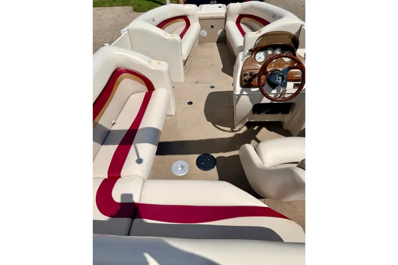 Slide: The Image of 2005 Princecraft Vacanza 210V O/B boat interior with red and white seating and wooden steering wheel. - 64