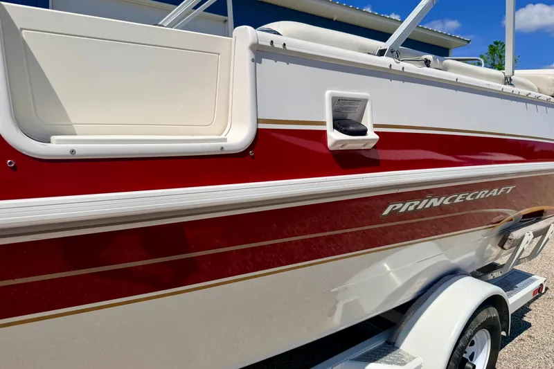 Slide: The Image of 2005 Princecraft Vacanza 210V O/B boat with red and white exterior on a trailer. - 13