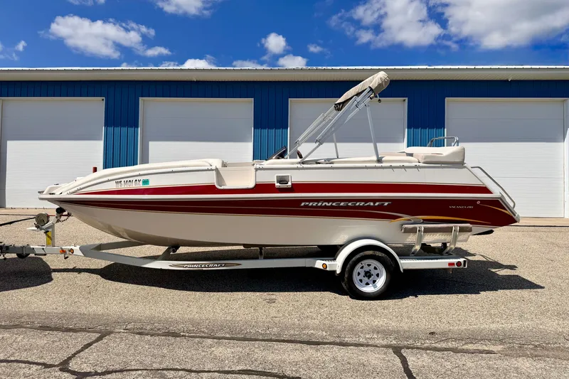 Slide: The Image of 2005 Princecraft Vacanza 210V O/B boat on trailer, parked outside blue building. - 3