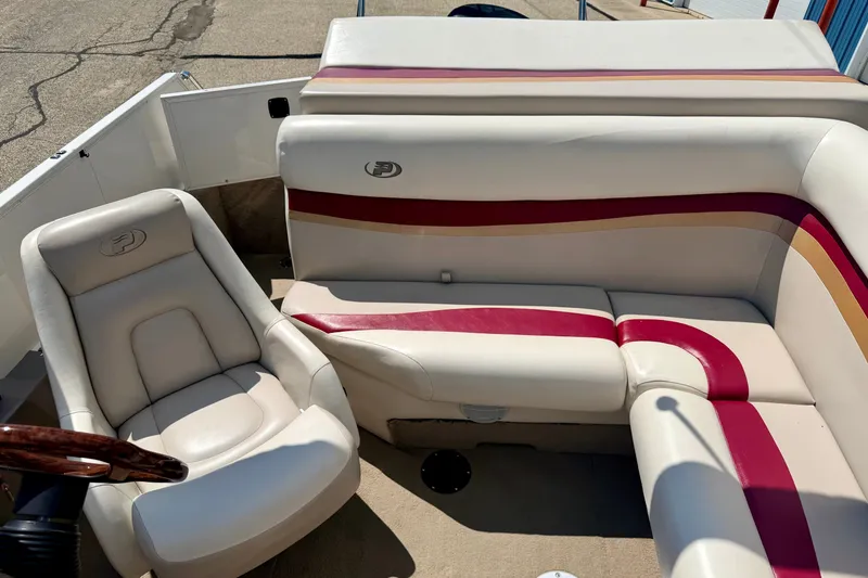 Slide: The Image of 2005 Princecraft Vacanza 210V O/B boat interior with beige and red seating. - 23