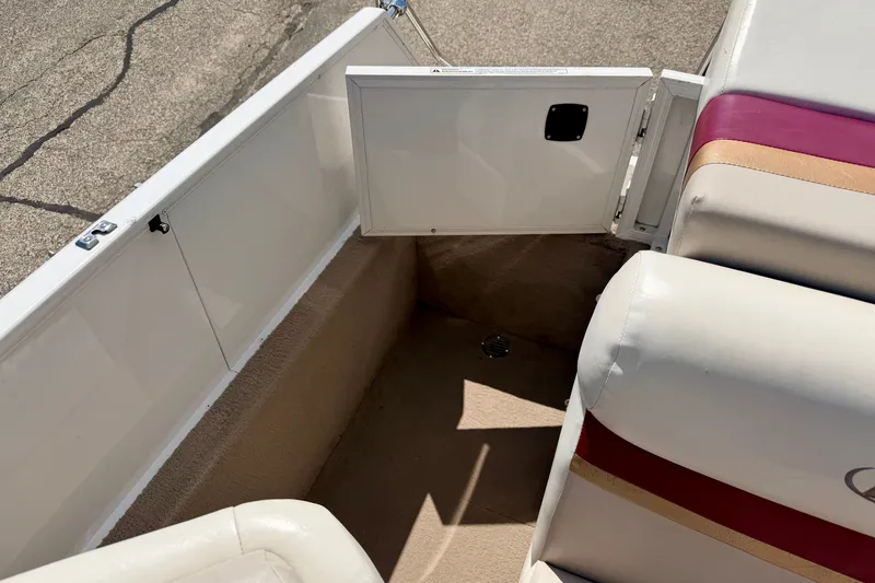 Slide: The Image of 2005 Princecraft Vacanza 210V O/B boat interior with open storage compartment and cushioned seating. - 24