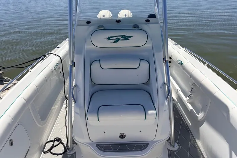 Slide: The Image of 2018 Glasstream 280 Pro-XS boat interior with white seating and logo, on calm water. - 15