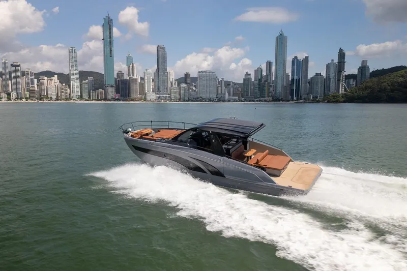 Slide: The Image of Luxury Hanover 447 yacht cruising near city skyline, 2026 model. - 2