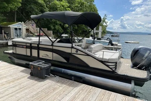 Slide: The Image of 2017 Bennington 24SSBXP pontoon boat docked by a scenic lake. - 6