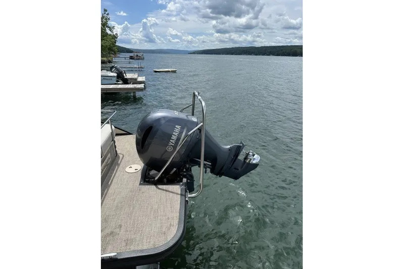 Slide: The Image of 2017 Bennington 24SSBXP pontoon boat with Yamaha outboard motor on a scenic lake. - 7