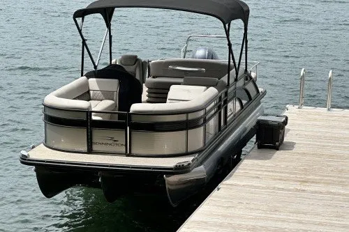 Slide: The Image of 2017 Bennington 24SSBXP pontoon boat docked on calm water. - 1