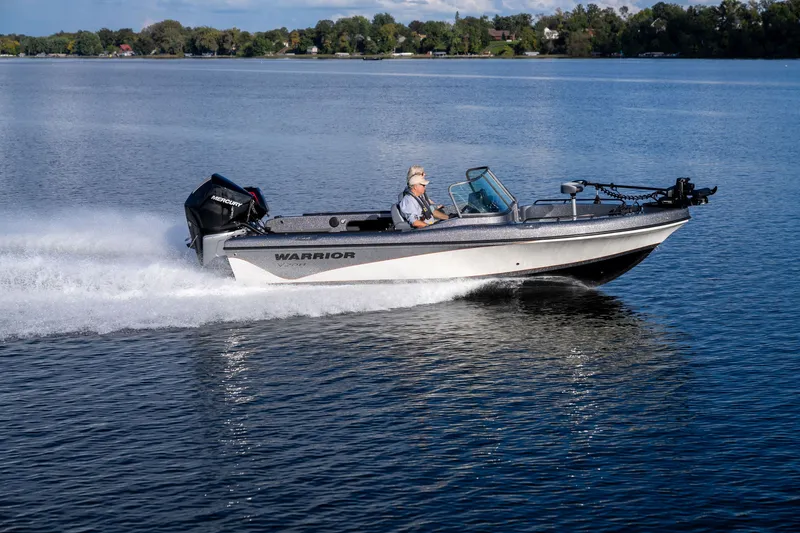 The Image of 2027 Warrior V208 boat cruising on a serene lake with a Mercury engine. - 0