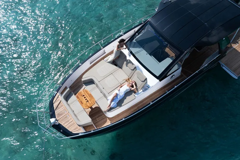 Slide: The Image of Aerial view of Hanover 447 yacht, 2026 model, with people relaxing on deck in clear blue water. - 15