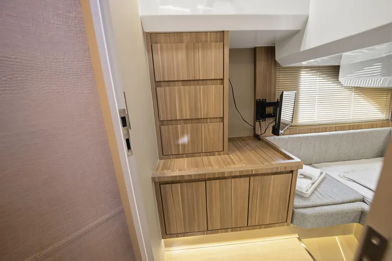 Slide: The Image of Modern interior of Hanover 447, 2026 model, featuring wood cabinetry and cozy seating area. - 50