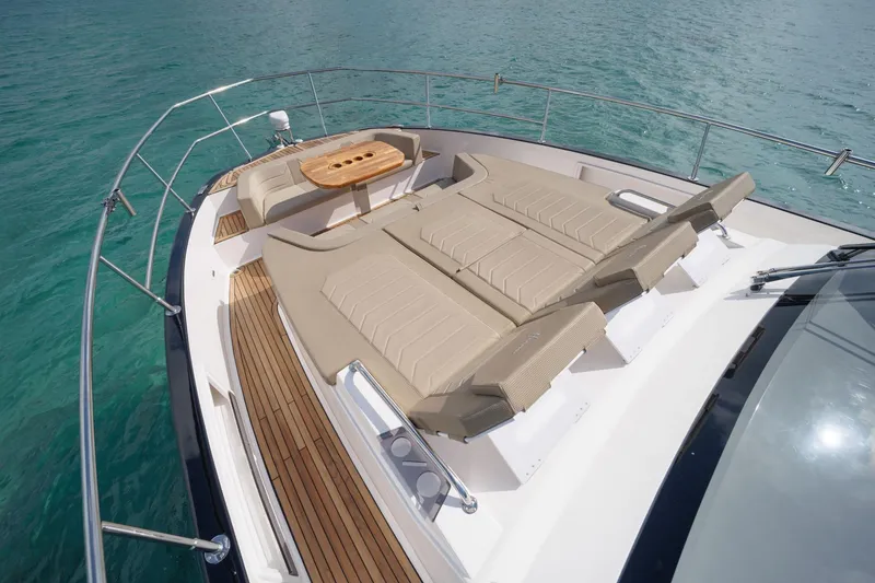 Slide: The Image of Luxurious Hanover 447 yacht deck with sun loungers and table, 2026 model, on clear blue water. - 36