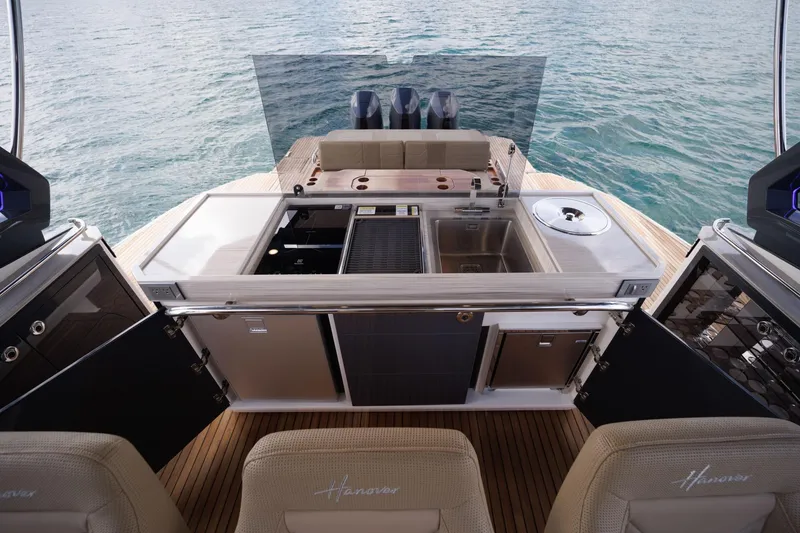 Slide: The Image of Luxury Hanover 447 yacht interior with modern kitchen, 2026 model, overlooking serene ocean waters. - 39