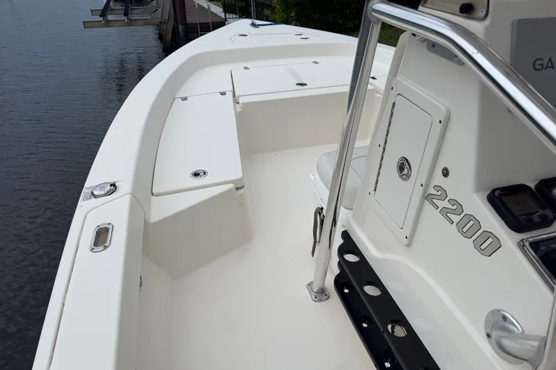 Slide: The Image of 2015 Pathfinder 2200 V Tournament Edition boat docked by the water. - 6