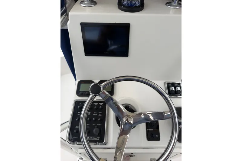 Slide: The Image of 2015 Pathfinder 2200 V Tournament Edition boat dashboard with steering wheel and controls. - 9