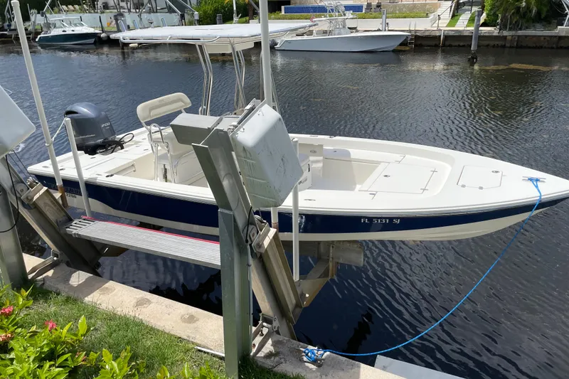The Image of 2015 Pathfinder 2200 V Tournament Edition boat docked on a lift by the water. - 1