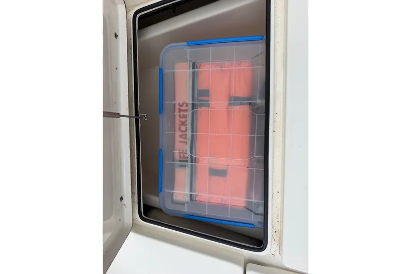 Slide: The Image of Storage compartment with life jackets on a 2015 Pathfinder 2200 V Tournament Edition boat. - 13