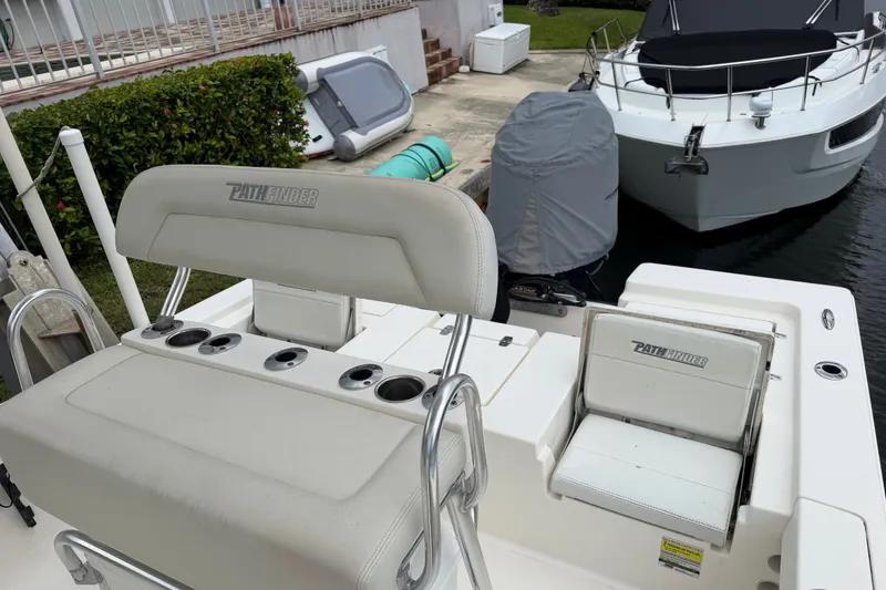Slide: The Image of 2015 Pathfinder 2200 V Tournament Edition boat docked near another vessel. - 7