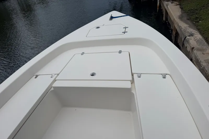 Slide: The Image of 2015 Pathfinder 2200 V Tournament Edition boat deck near water. - 8