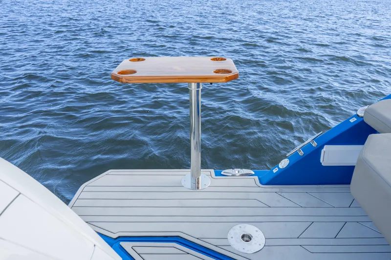 Slide: The Image of Luxury Hanover 347 boat deck with wooden table, 2026 model, overlooking serene water. - 15