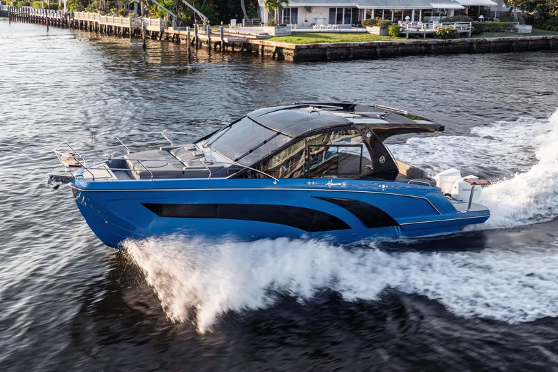 Slide: The Image of 2026 Hanover 347 boat cruising on water near a residential area. - 2