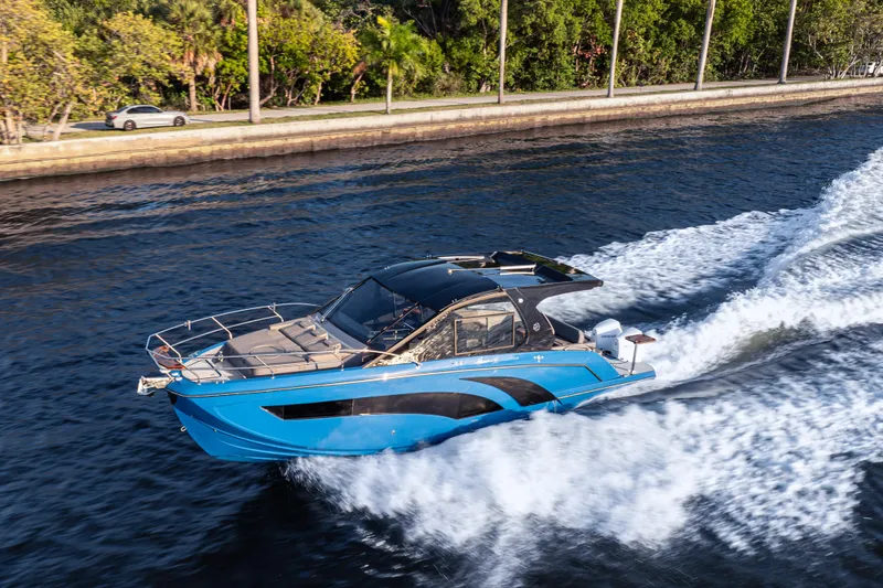Slide: The Image of 2026 Hanover 347 boat cruising on a scenic waterway with lush greenery. - 0