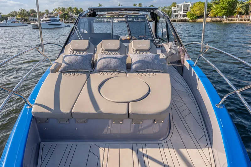 Slide: The Image of Luxurious 2026 Hanover 347 yacht with plush sunbathing area on a serene waterway. - 28