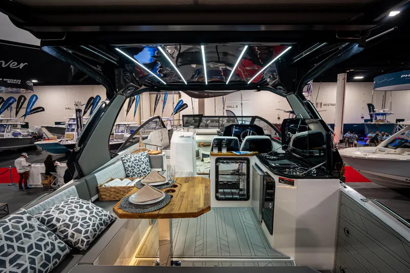 Slide: The Image of Luxurious Hanover 347 boat interior with modern design, featuring elegant seating and dining area, 2026 model. - 3