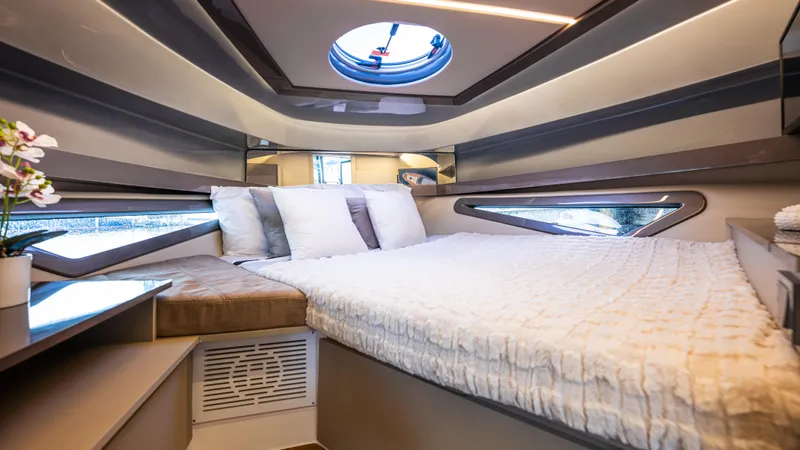 Slide: The Image of Luxurious cabin interior of 2025 Hanover 415 yacht with modern bedding and porthole. - 8