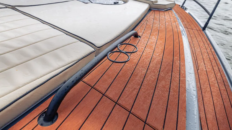 Slide: The Image of The image shows the deck of a 2027 Hanover 415 boat with sleek wooden elements. - 40
